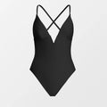 Black swimsuit with criss-cross straps on a light gray background