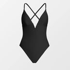 Black swimsuit with criss-cross straps on a light gray background