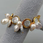 Bracelet with pearls and gold accents on a gray stand