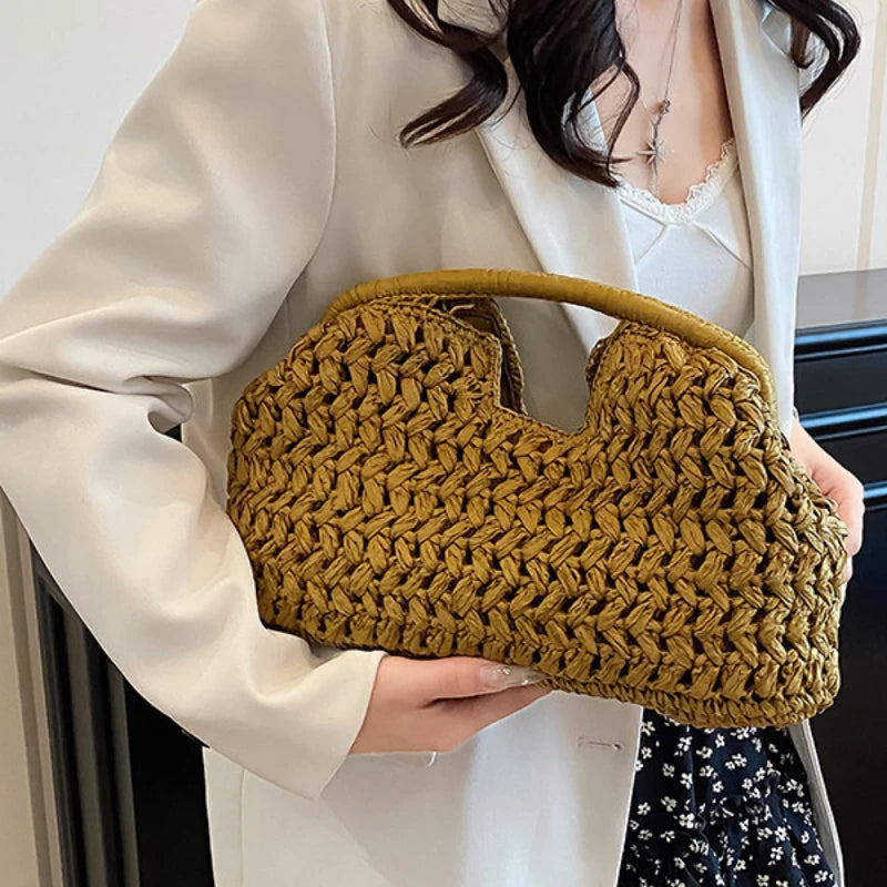 Person holding a mustard yellow woven handbag