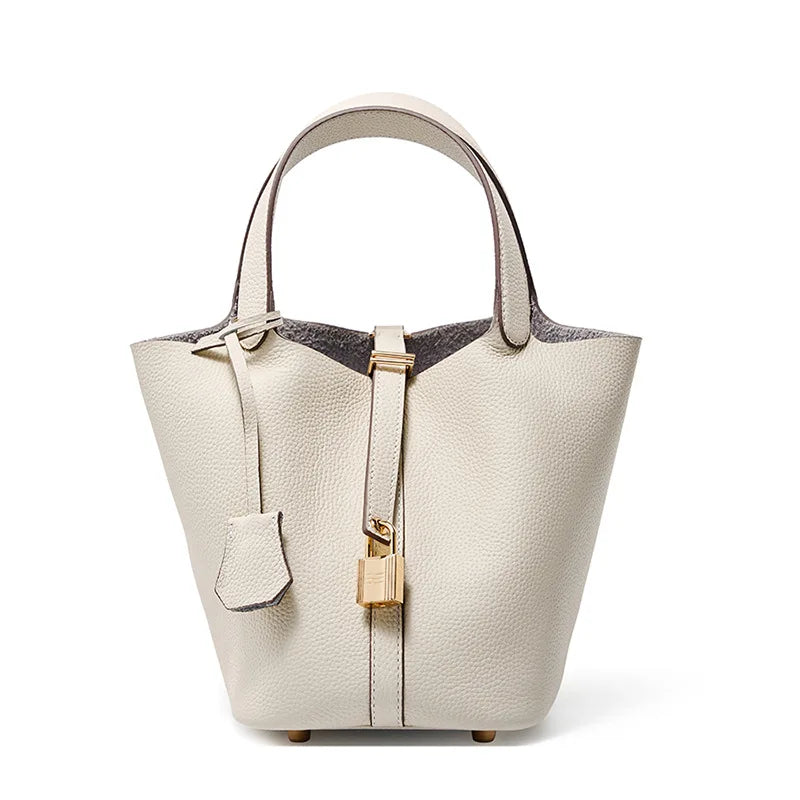 Beige handbag with gold accents on a white background