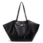 Black handbag with a gold clasp on a white background