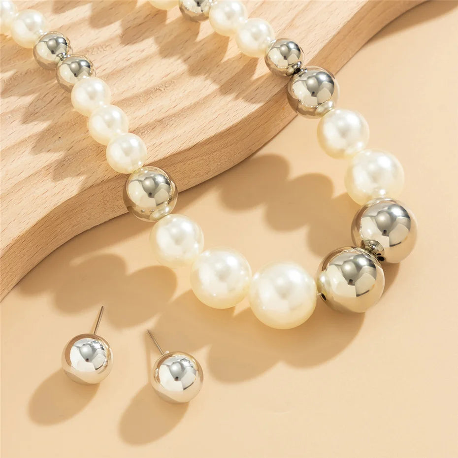 Pearl and silver beaded necklace on a wooden surface
