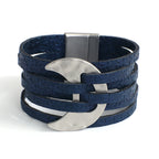 Blue leather bracelet with silver crescent moon charms on a white background