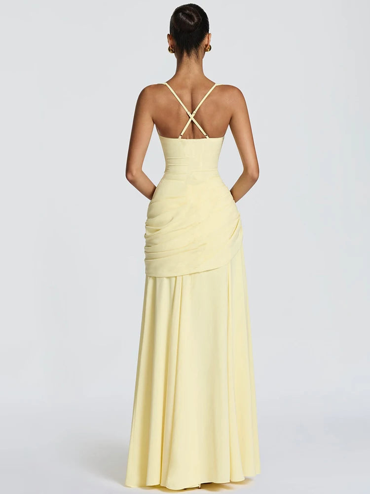 Woman wearing a light yellow evening gown with a white background