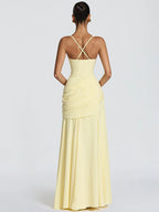 Woman wearing a light yellow evening gown with a white background
