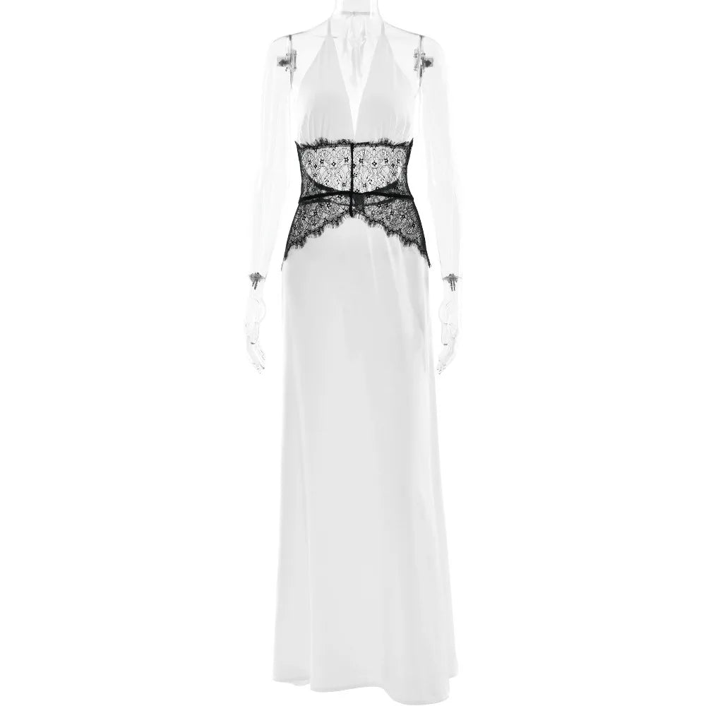 White sleeveless dress with black lace detailing on a white background