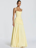 Woman wearing a light yellow evening gown on a white background