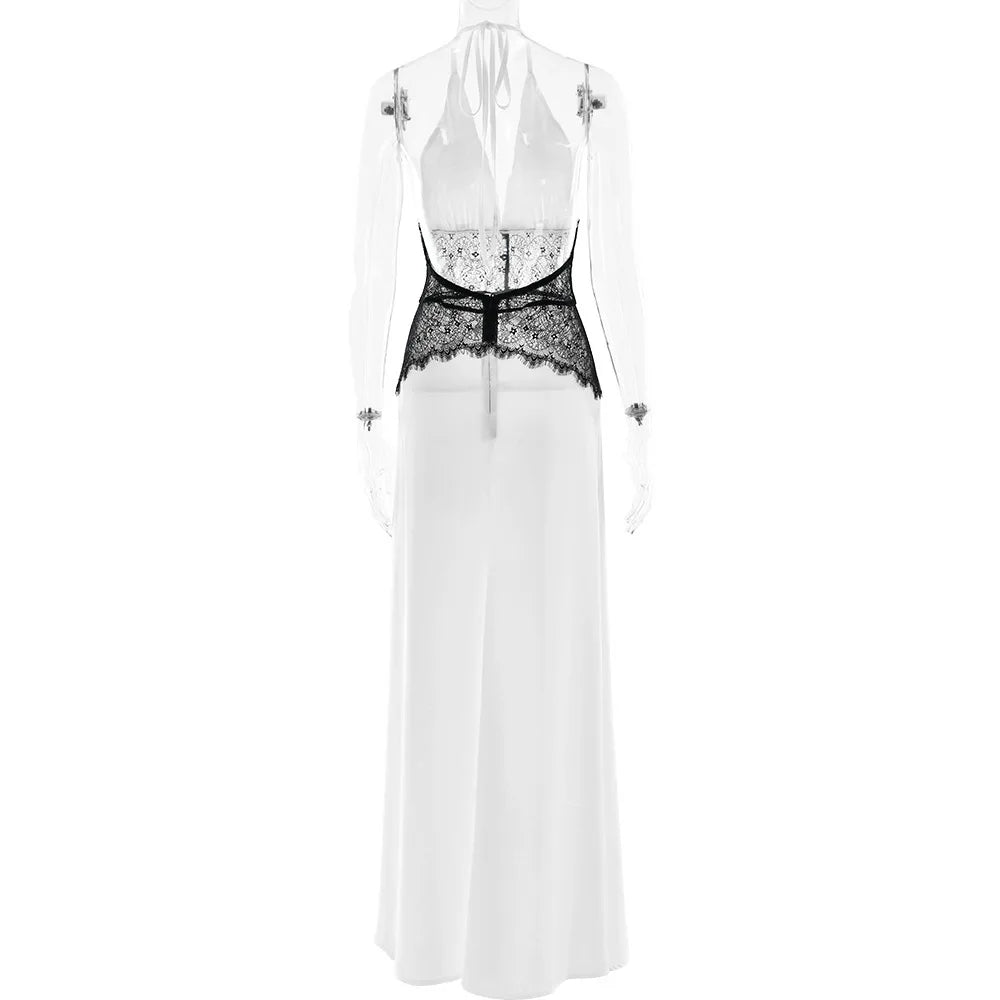White dress with black lace detailing on a white background