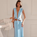 Woman wearing a light blue dress with a plain background