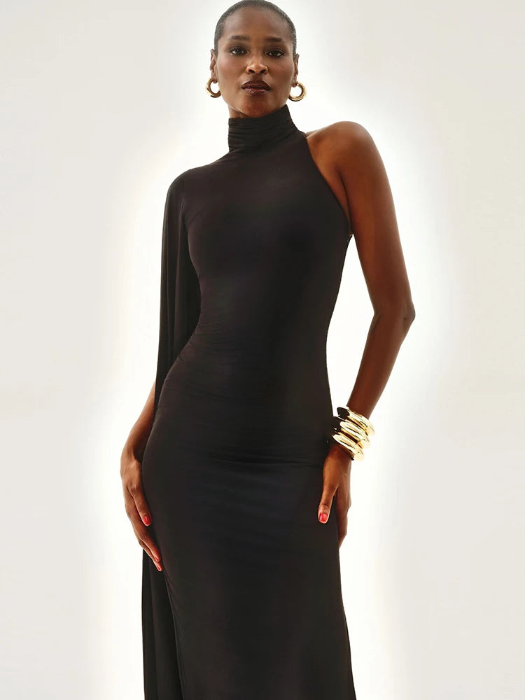 Woman wearing a black high-neck dress against a white background