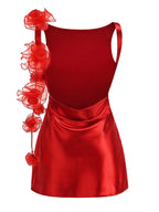 Red satin dress with floral embellishments on a white background