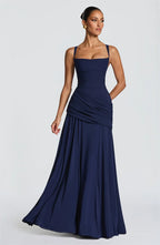 Woman wearing a navy blue evening gown on a white background