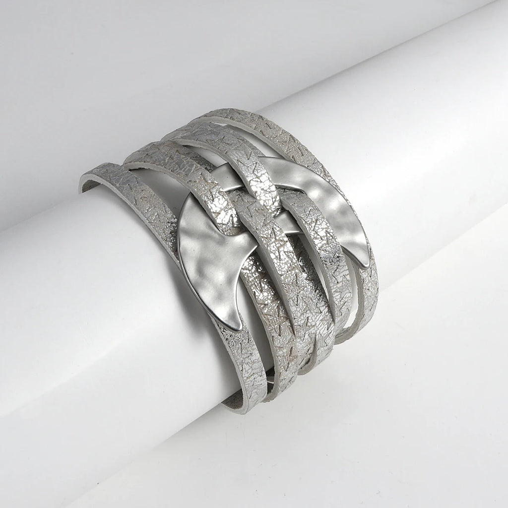 Silver bracelet with braided design on a white surface