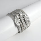 Silver bracelet with braided design on a white surface