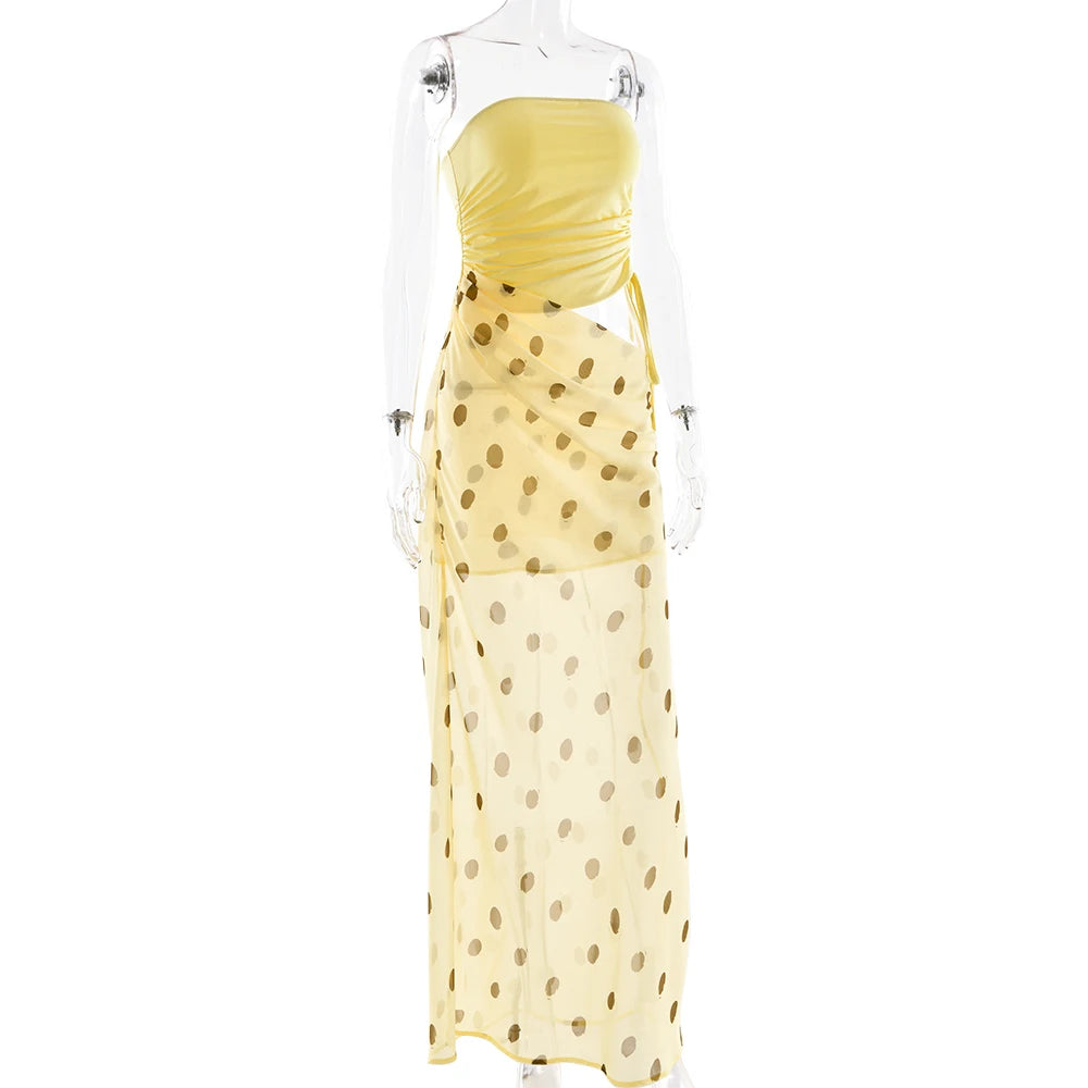 Yellow strapless dress with gold polka dots on a mannequin against a white background