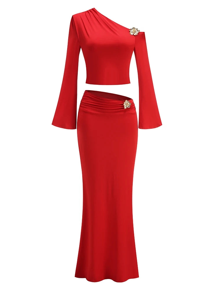Red two-piece outfit with long sleeves and a fitted skirt on a white background