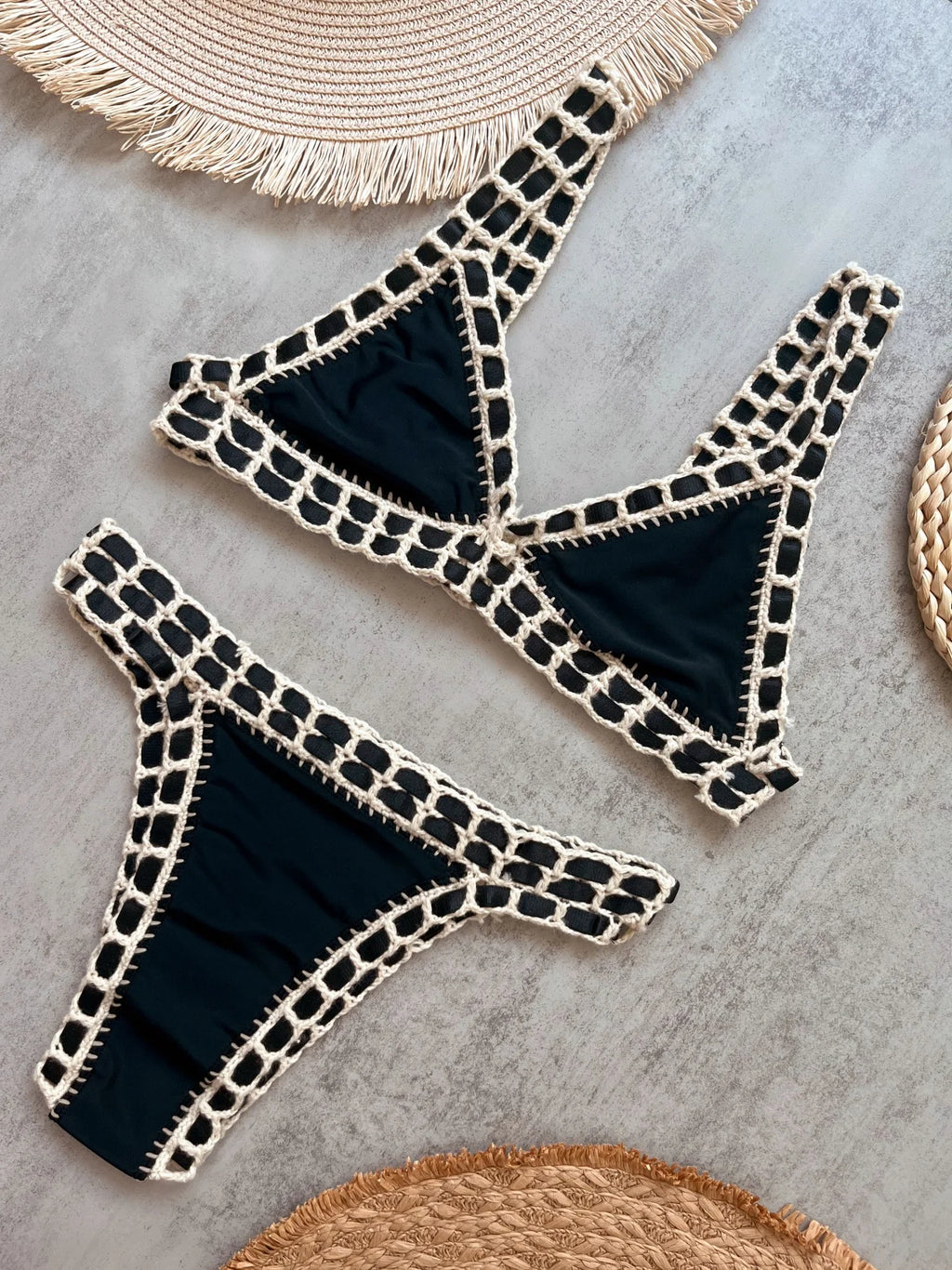 Black bikini with white patterns on a gray surface