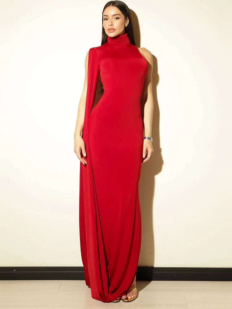 Woman wearing a red evening gown against a plain background