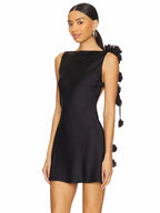 Woman wearing a black dress with decorative elements on a white background