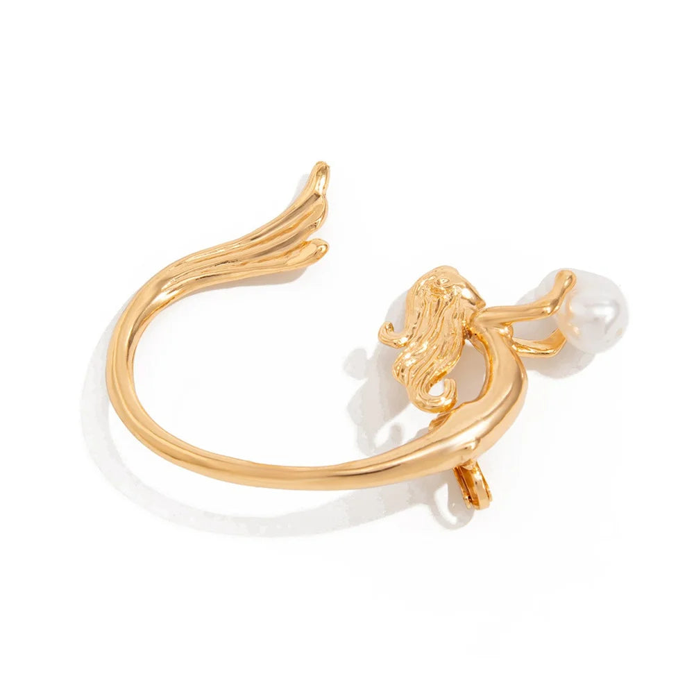 Gold ring with a lion head and pearl on a white background