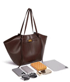 Brown tote bag with daily necessities on a white background