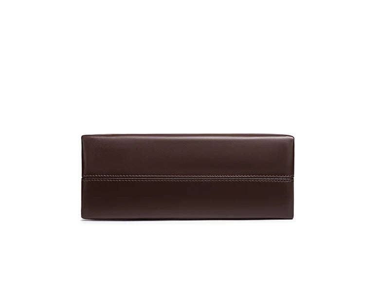 A dark brown leather clutch wallet with a horizontal stitched seam, shown from the front on a solid white background.
