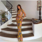 Woman in a floral outfit standing on a staircase in a home setting