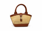 Woven handbag with brown leather accents on a white background