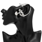 Silver earring on a black mannequin ear