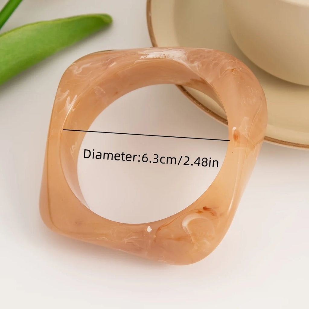 Beige ring with measurement text on a white background