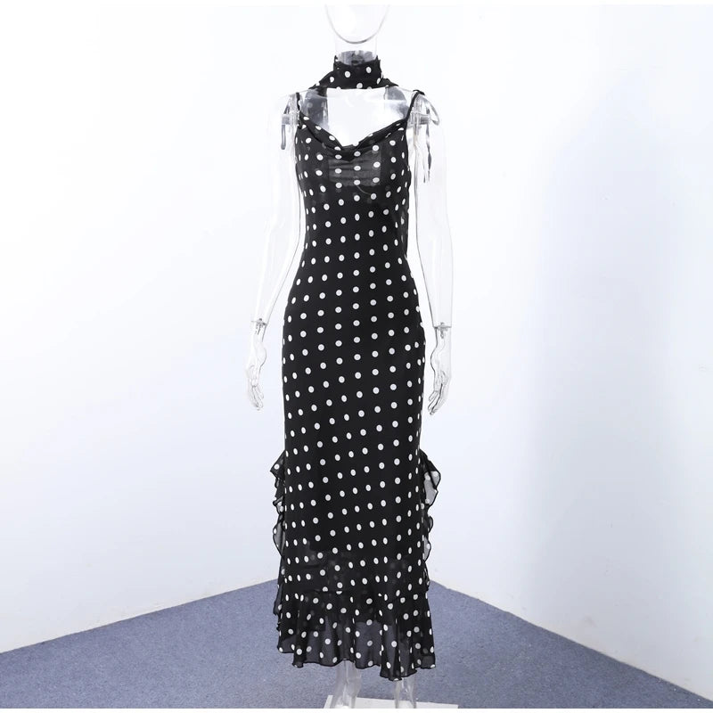 Black dress with white polka dots on a mannequin against a white background