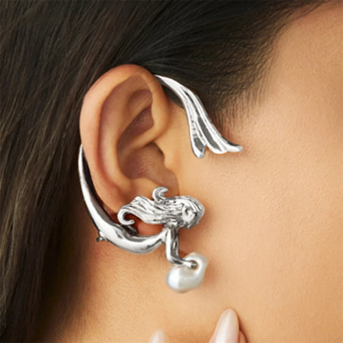 Silver ear cuff with pearl accent worn by a person