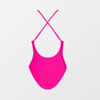 Pink swimsuit with criss-cross straps on a light gray background