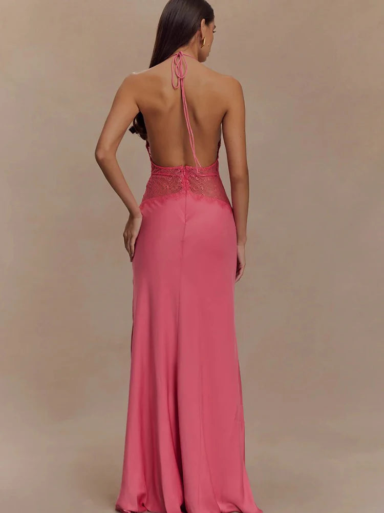 Pink evening gown with open back on a model against a beige background