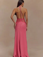 Pink evening gown with open back on a model against a beige background