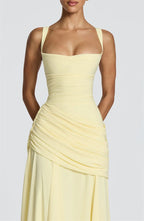 Yellow strapless dress on a plain background
