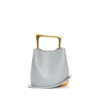 Light blue handbag with a gold handle on a white background