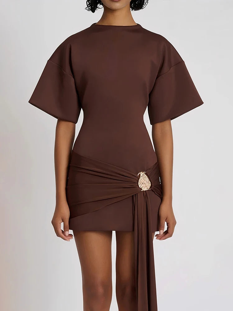 Brown dress with a draped design on a white background