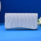Silver pleated clutch bag on a blue background