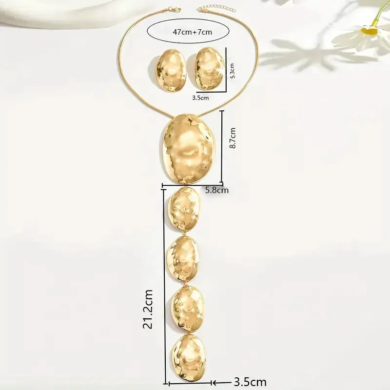 Gold necklace and earrings with measurements on a white background