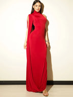 Woman wearing a red evening gown against a plain background
