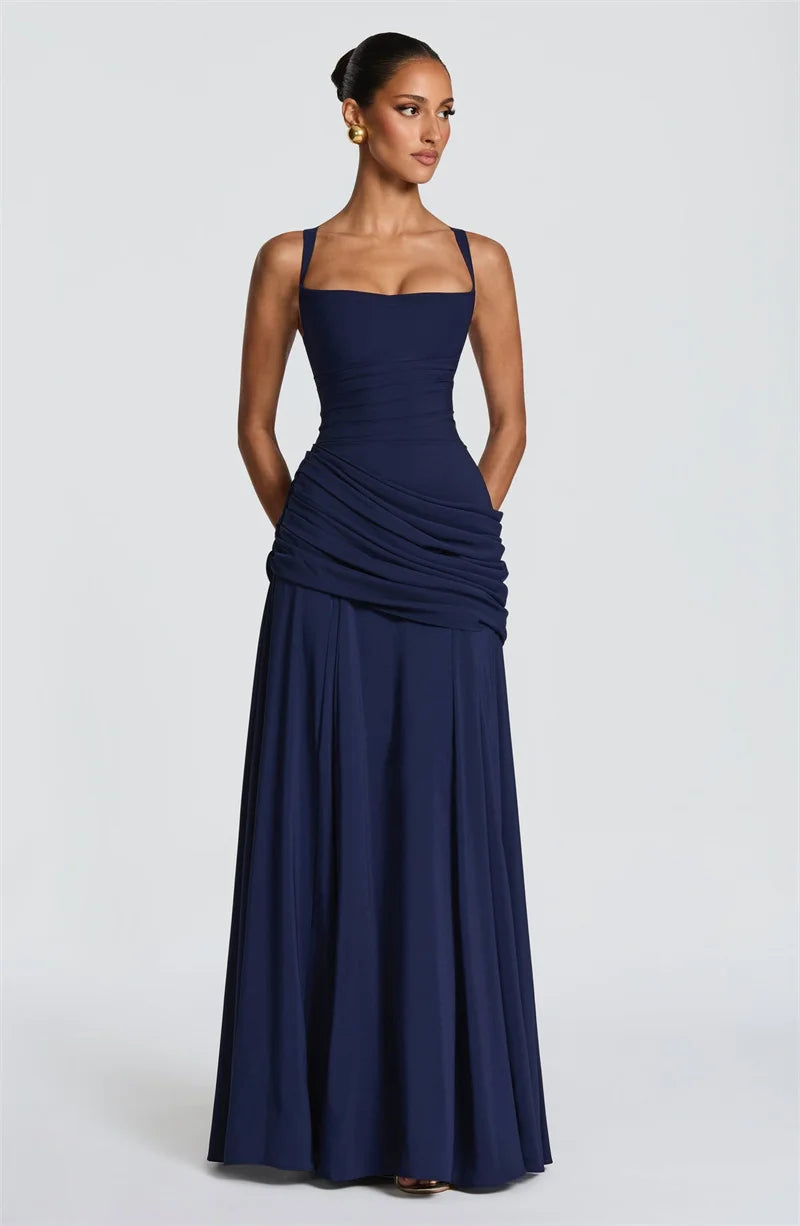 Navy blue evening gown on a model against a white background