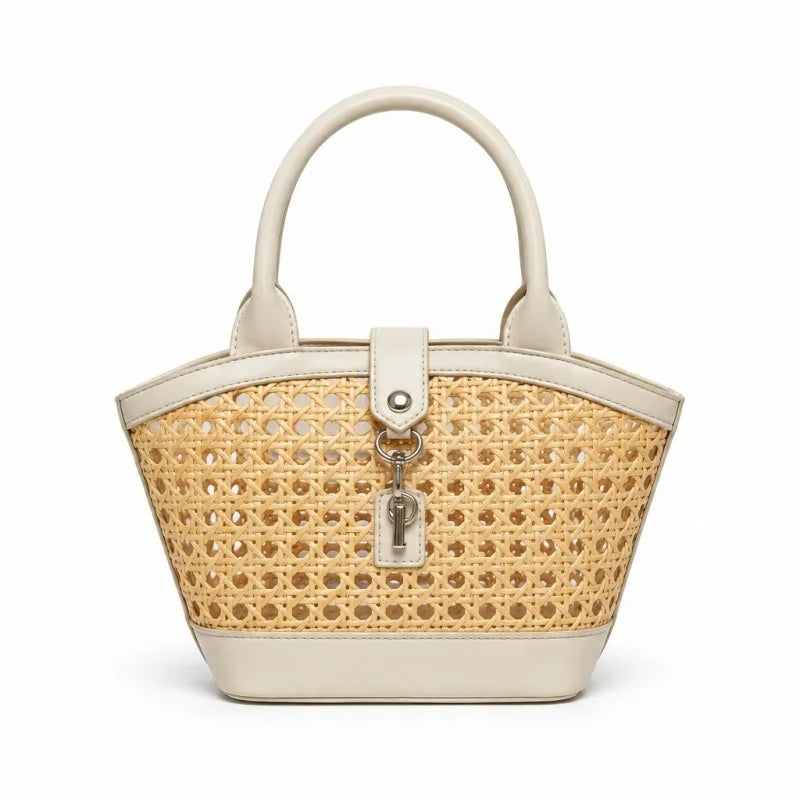 A small structured handbag with a natural woven cane body, cream-colored faux leather trim, double top handles, and a silver keyring clasp, shown on a plain white background.