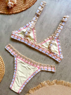 Bikini set with mirror-like embellishments on a textured surface