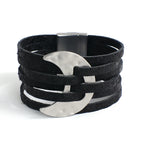 Black leather bracelet with silver crescent moon charm on a white background