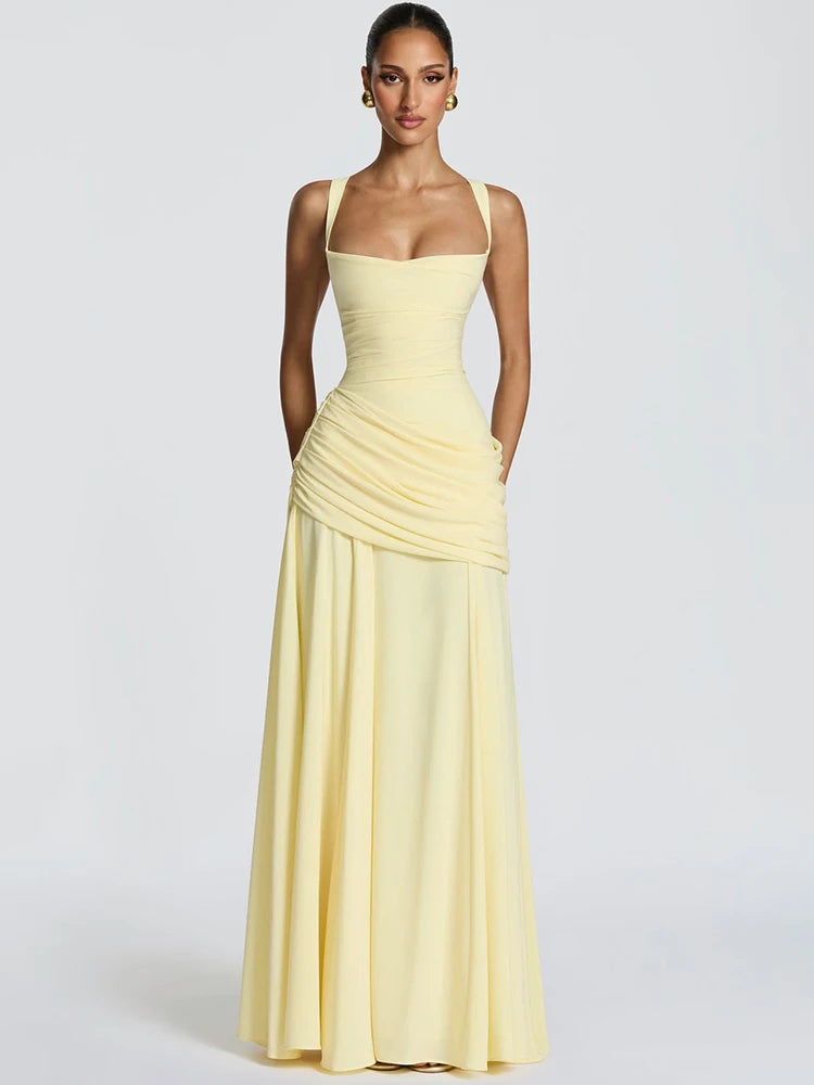 Woman wearing a yellow strapless gown on a white background