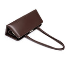 Brown leather handbag with a strap on a white background