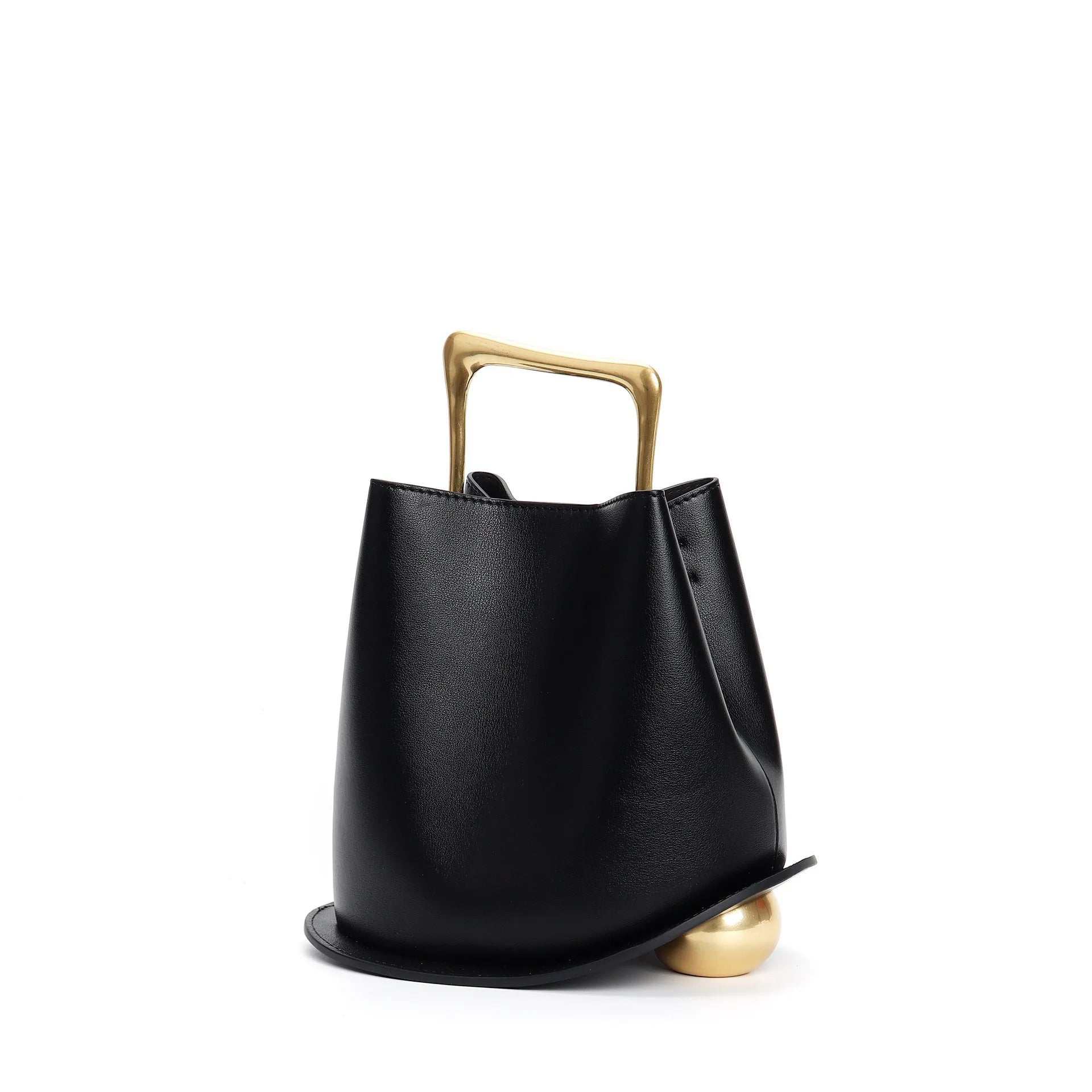 Black handbag with a gold handle on a white background