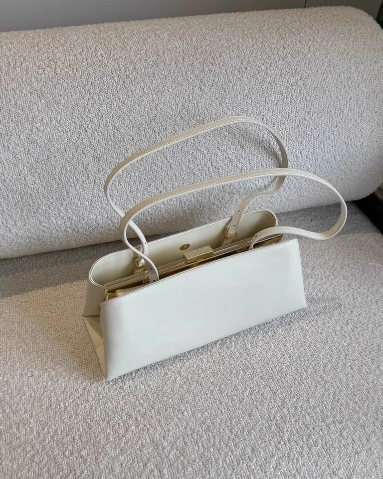 White handbag on a textured surface
